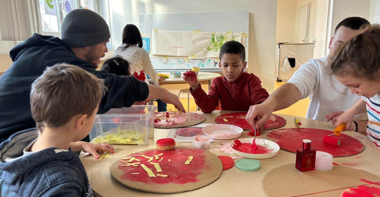 Kids sitting around a table and playing together